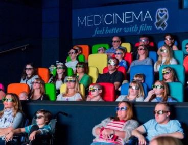 Families watching movie in Medicinema